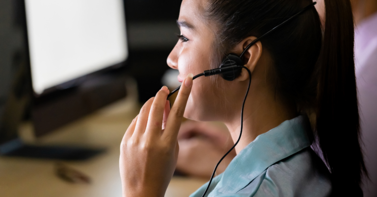 woman on a computer talking to a customer.