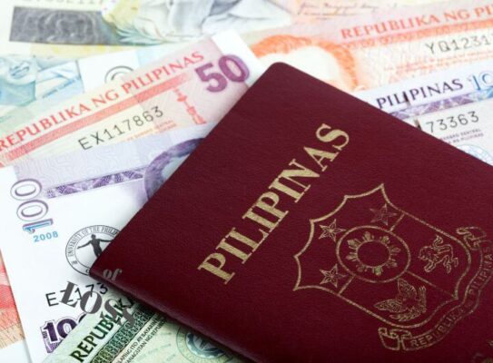 showing passport with philippine money